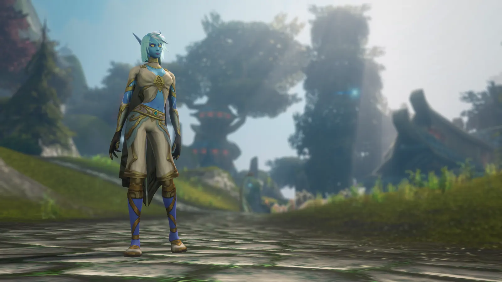 A Skyborne woman in a tan and gold outfit on a stone path in a misty forest
