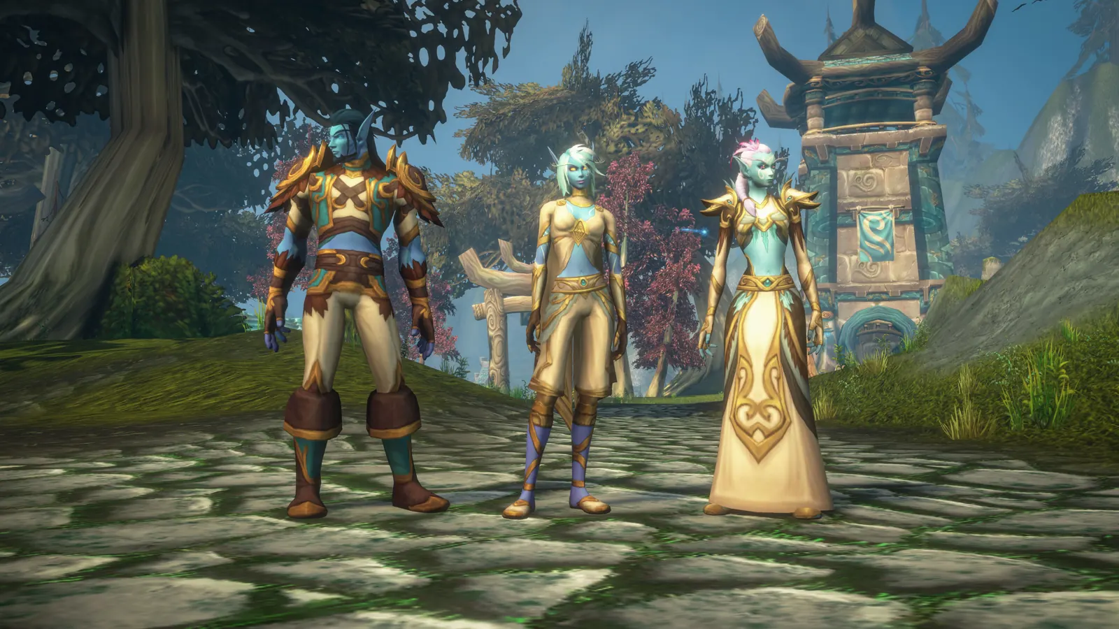Three Skyborne on a stone path before a shrine tower: a man in gold-trimmed armour and two women in tan and gold