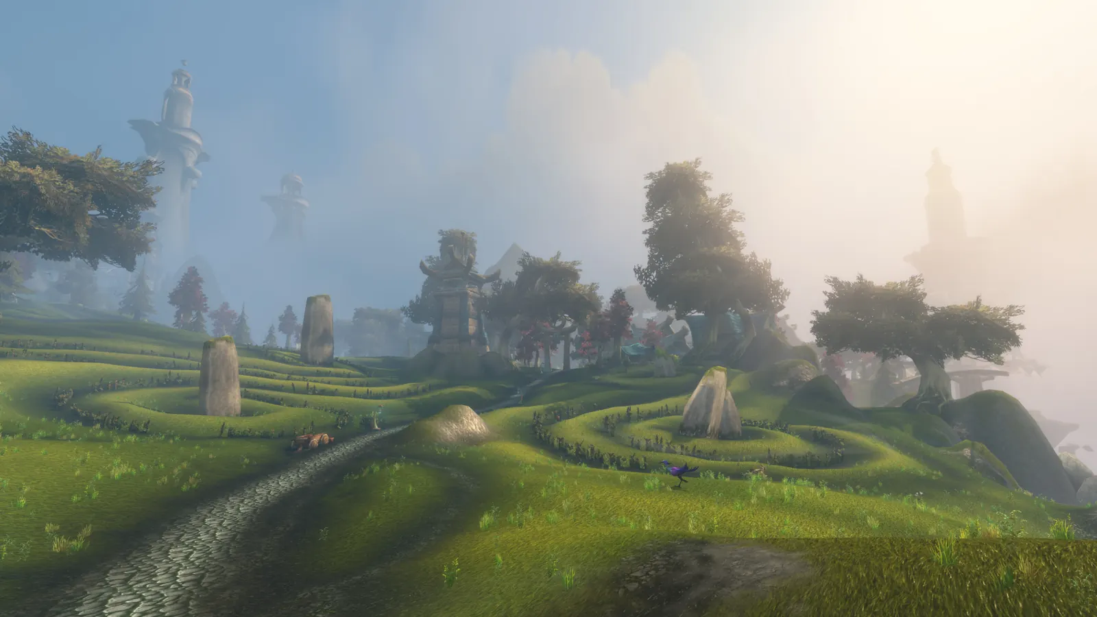 Spiral hedges and standing stones across a misty meadow
